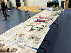 Tables filled with all kinds of recycled materials, ready to be made into puppets!